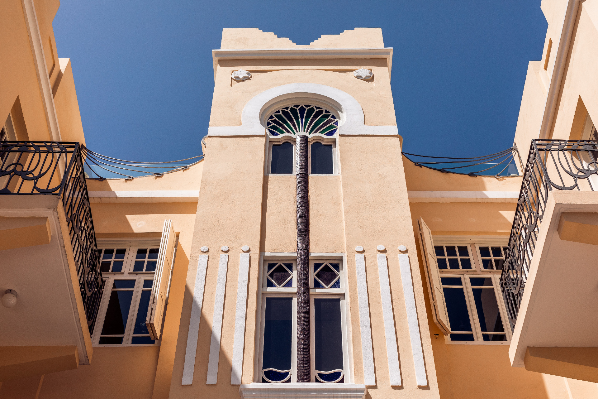 Historic House of Palm facade with palm tree